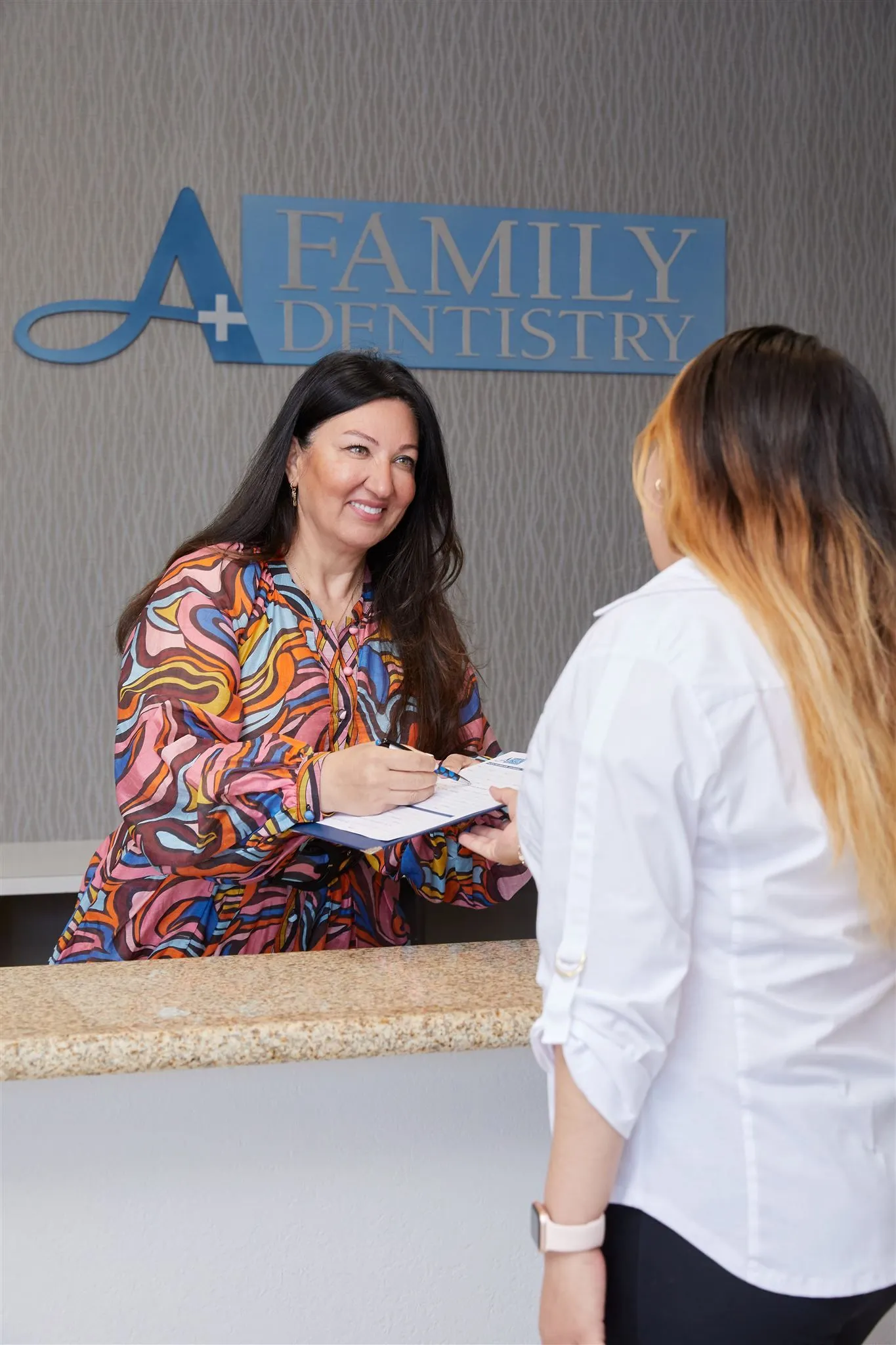 A patient and dentist having a conversation during a dental appointment