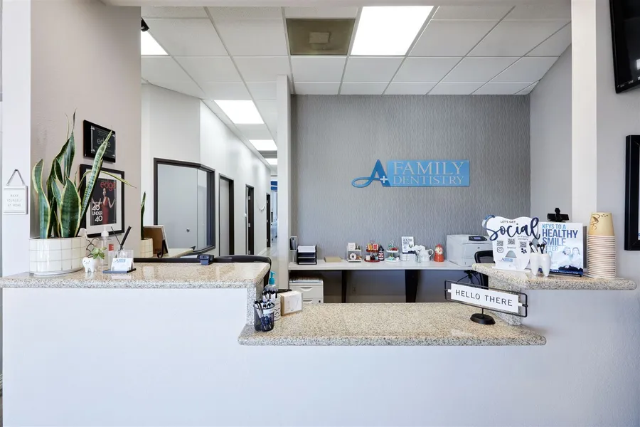 A dental office with a counter and a sign on the wall
