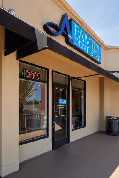 The front of a family dentistry with an open sign