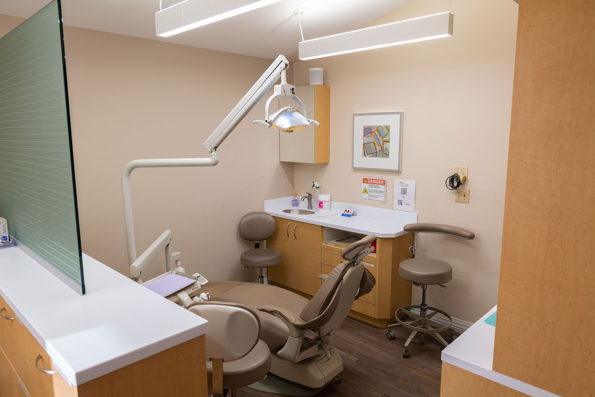 A dental office with a dental chair and a counter.