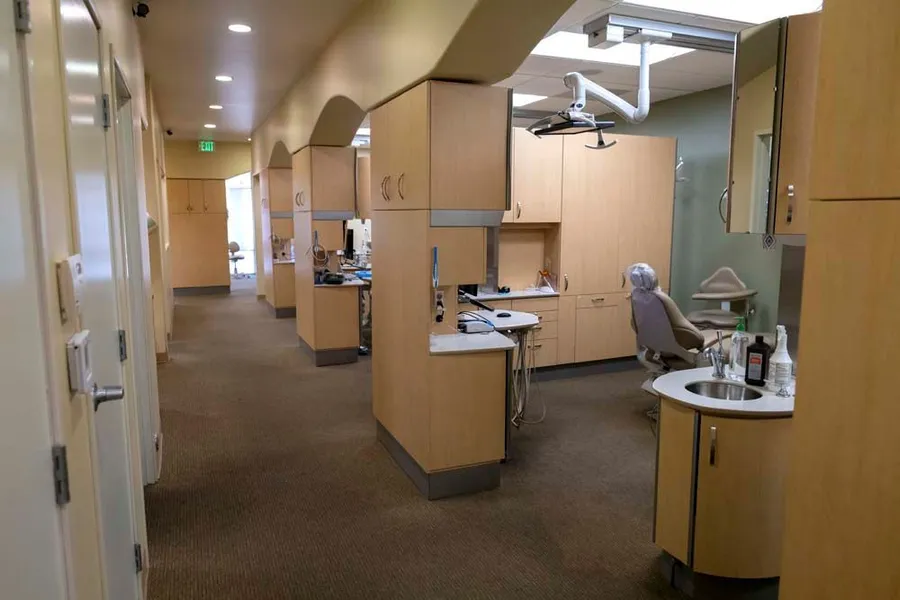 A dental office with a dental chair and a desk