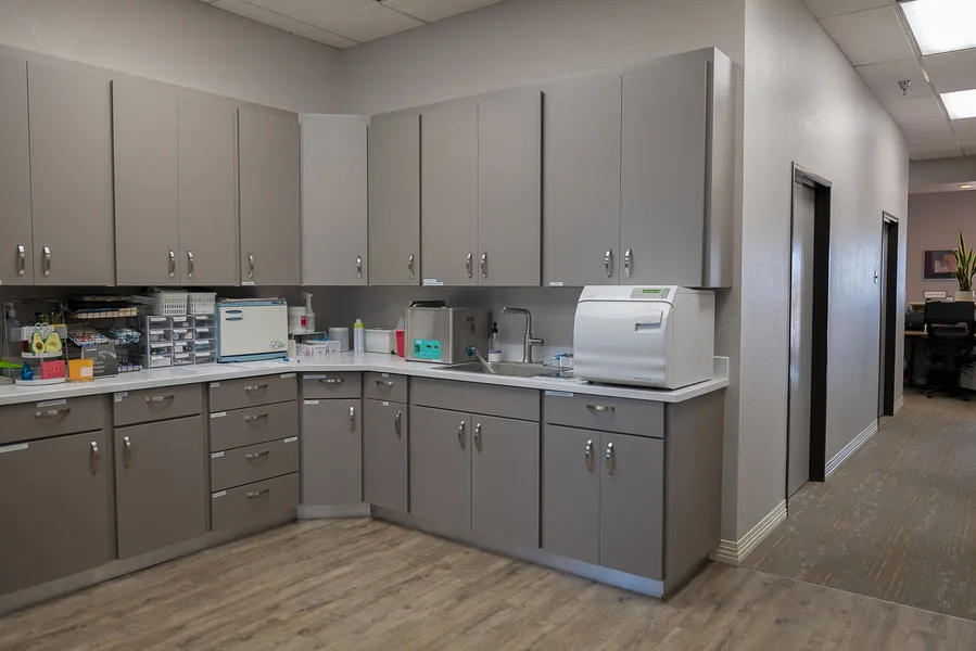 A kitchen with a lot of cabinets and appliances in it.
