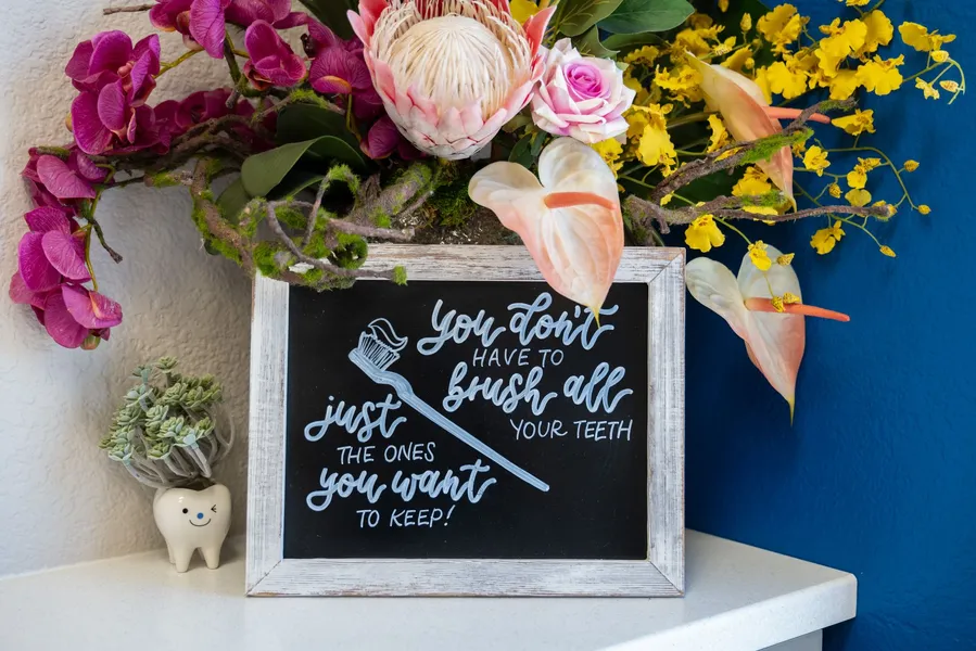 A sign that says "you don't have to brush all your teeth just the ones you want to keep"